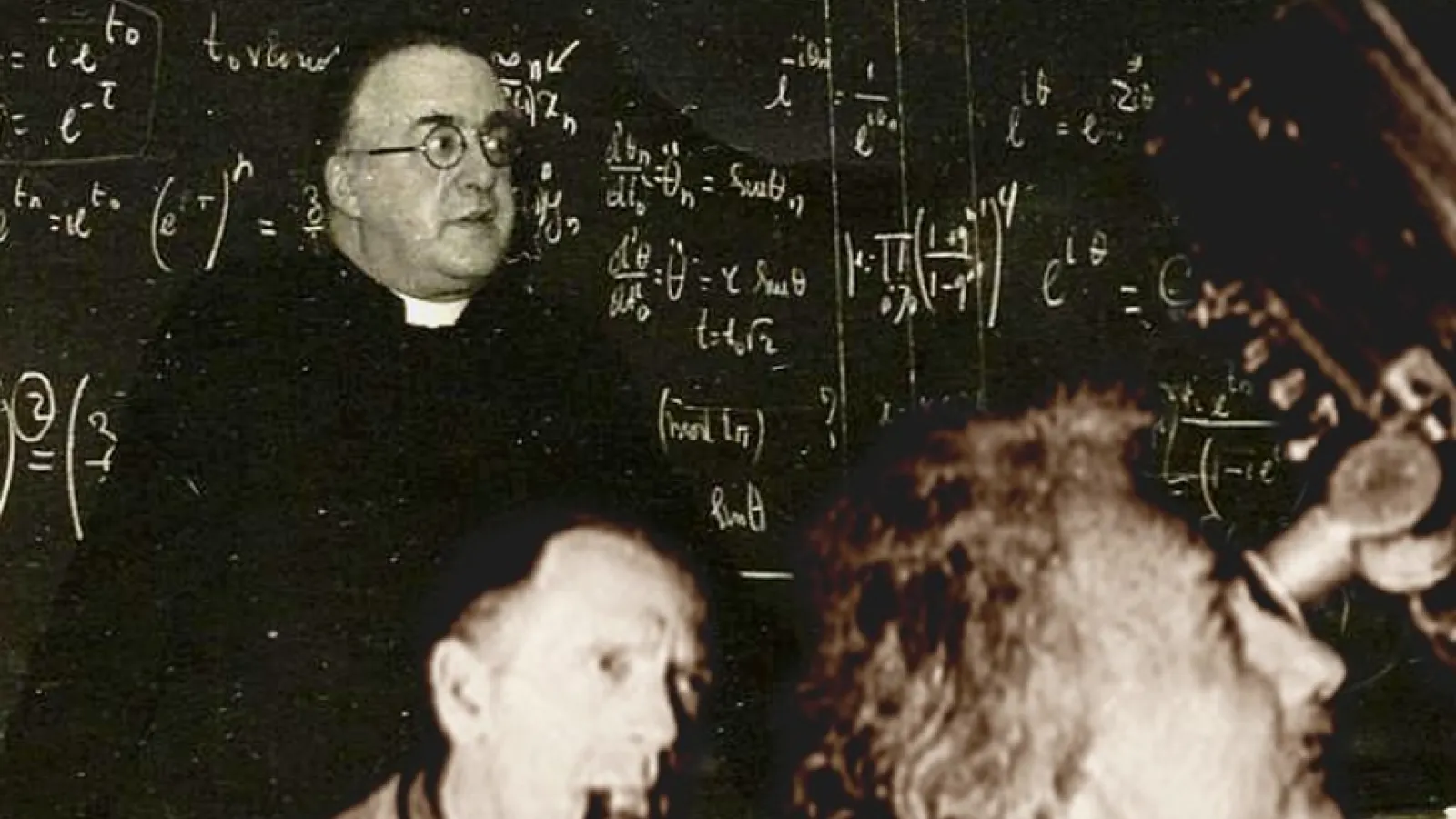 Lemaitre in front of a chalkboard