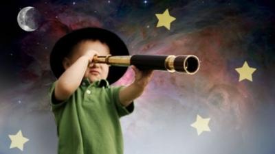 Child looking through a telescope