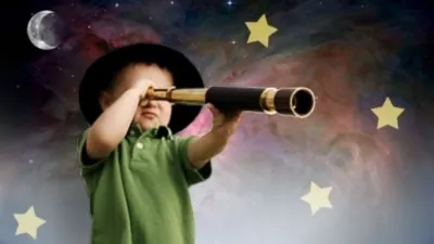 Child looking through a telescope