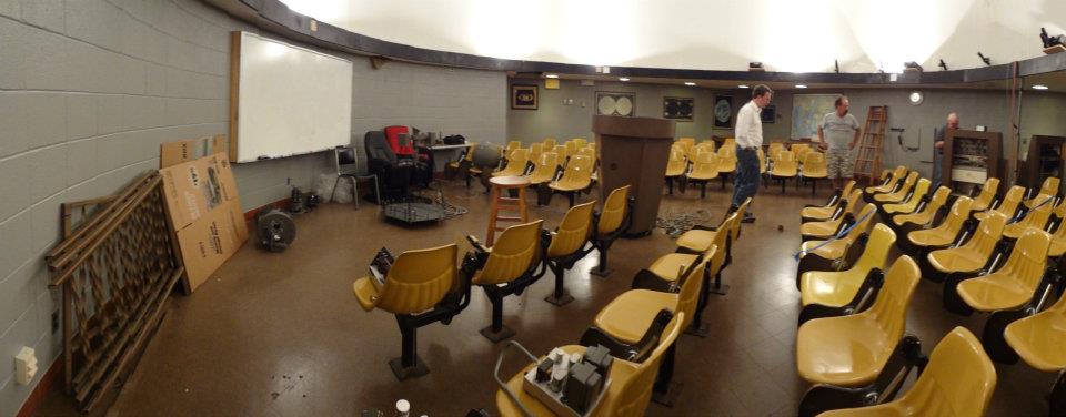A panoramic view of the planetarium with pieces of the projector and console spread throught the room.
